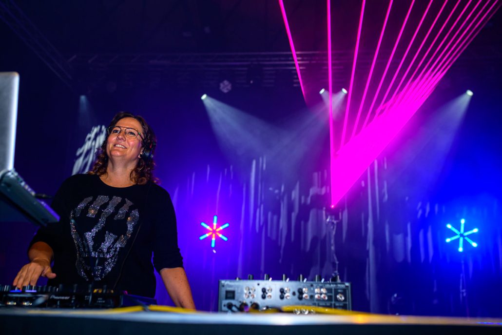 DJane am Pult vor pinken Laserstrahlen beim brillenball OpenAir 2021